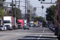 Parked cargo container trucks are seen in a street, Wednesday, Oct. 20, 2021 in Wilmington, Calif. California Gov. Gavin Newsom on Wednesday issued an order that aims to ease bottlenecks at the ports of Los Angeles and Long Beach that have spilled over into neighborhoods where cargo trucks are clogging residential streets. (AP Photo/Ringo H.W. Chiu)