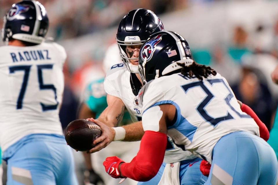 Tennessee Titans quarterback Will Levis (8) hands off to running back Derrick Henry (22) during the second quarter against the Miami Dolphins at Hard Rock Stadium in Miami, Fla., Monday, Dec. 11, 2023.