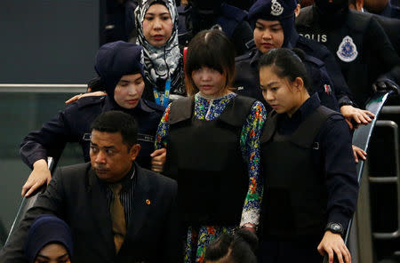 Vietnamese Doan Thi Huong, who is on trial for the killing of Kim Jong Nam, the estranged half-brother of North Korea's leader, is escorted as she revisits the Kuala Lumpur International Airport 2 in Sepang, Malaysia October 24, 2017. REUTERS/Lai Seng Sin