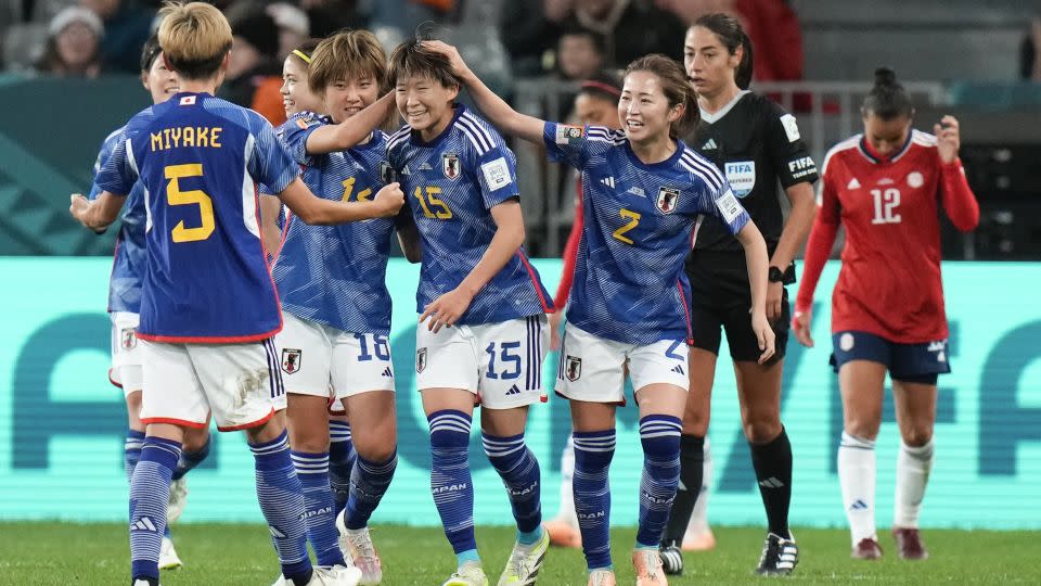 Fujino (middle) is congratulated by her teammates after scoring Japan's second goal against Costa Rica. - Alessandra Tarantino/AP
