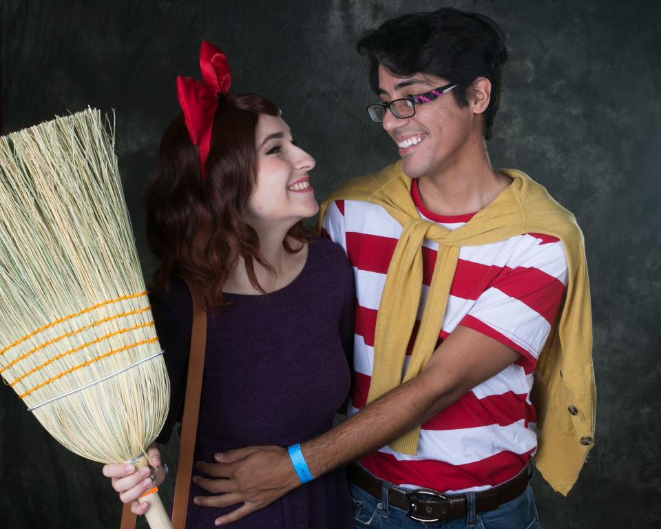 Marina Sharpe (left) and Thomas Knight (right) dressed as characters from Kiki's Delivery Service stand in the Azcentral photo booth during Phoenix Fan Fusion at the Phoenix Convention Center in Phoenix on May 24, 2019. 