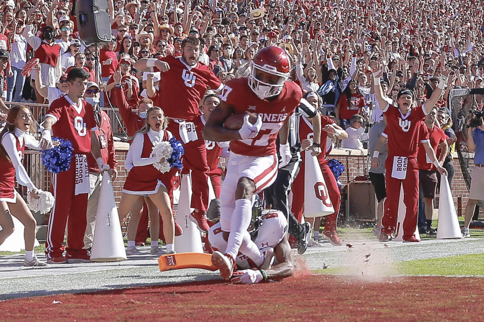 FILE - Oklahoma wide receiver Marvin Mims (17) runs in for a touchdown ahead of Texas Tech defensive back Malik Dunlap (8) during the first half an NCAA college football game, Saturday, Oct. 30, 2021, in Norman, Okla. (AP Photo/Alonzo Adams, File)