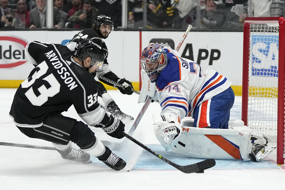 Los Angeles Kings right wing Viktor Arvidsson, left, tries to score on Edmonton Oilers goaltender Stuart Skinner during the second period in Game 3 of an NHL hockey Stanley Cup first-round playoff series Friday, April 21, 2023, in Los Angeles. (AP Photo/Mark J. Terrill)