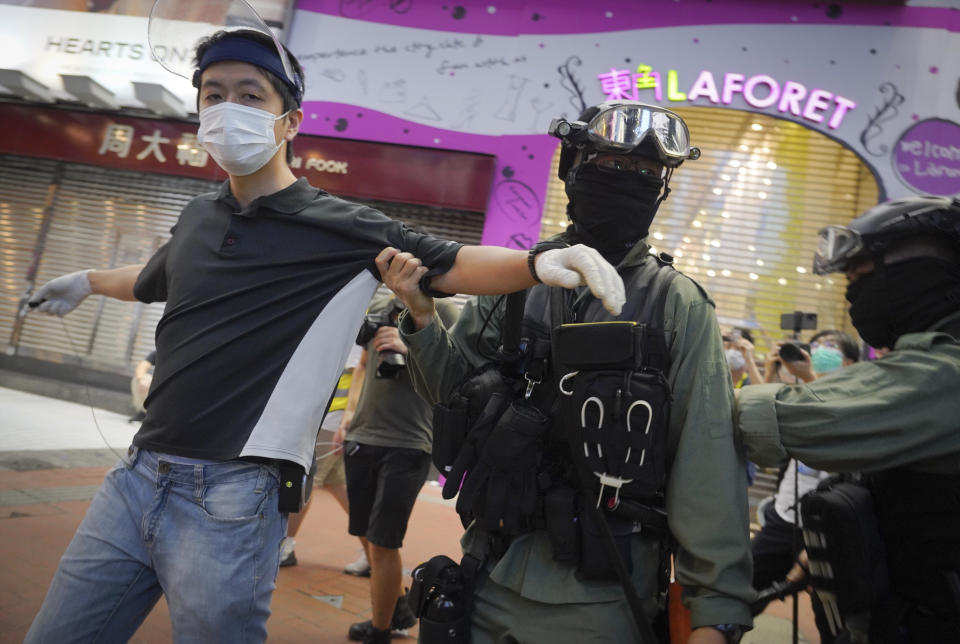 Hui Chi-fung, a Democratic Party politician detained by riot police during a protest in Causeway Bay, Hong Kong, Friday, June 12, 2020. Protesters in Hong Kong got its government to withdraw extradition legislation last year, but now they're getting a more dreaded national security law, and the message from Beijing is that protest is futile. (AP Photo/Vincent Yu)