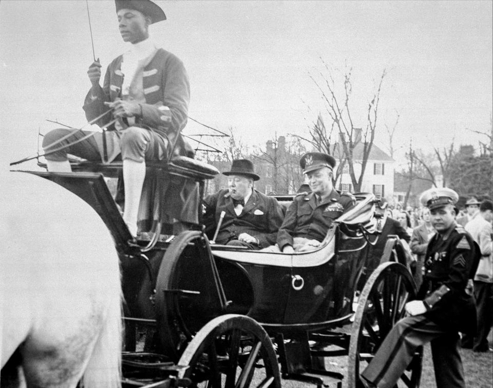 Colonial Williamsburg coachman Benjamin Spraggins sits atop a carriage holding former British Prime Minister Winston Churchill and then-Gen. Dwight D. Eisenhower in Williamsburg, Va., on March 8, 1946. The living history museum is honoring Spraggins, a Black man who worked at the museum during the era of segregation, by naming a new carriage after him. The tribute is part of the museum’s ongoing reckoning over race and its past storytelling about the country’s origins and the role of Black Americans. (Photo courtesy of the Colonial Williamsburg Foundation via AP)