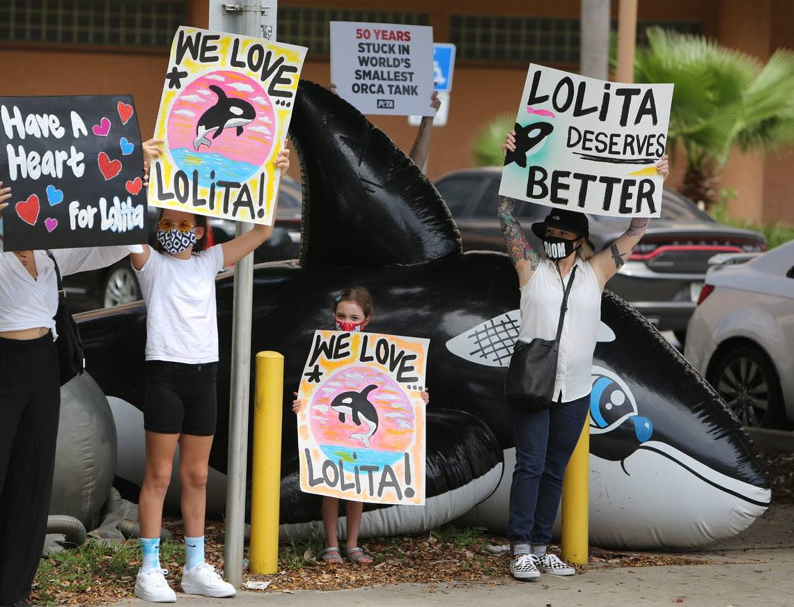 Sisters Olivia, then-11, and Melody Ruane, then-6, stand with their mom, Angie Varela holding signs during a PETA rally on behalf of freeing Lolita from Seaquarium captivity, outside of Miami-Dade State Attorney Katherine Fernandez Rundle’s office on June 9, 2020.