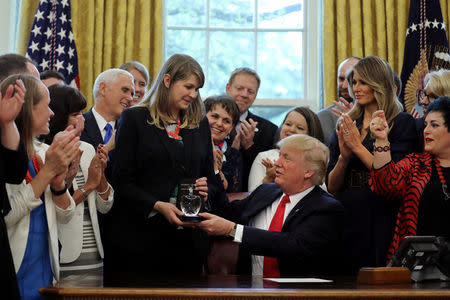 Sydney Chaffee receives the 2017 National Teacher of the Year award from U.S. President Donald Trump during an event at the Oval Office of the White House in Washington, U.S., April 26, 2017. REUTERS/Carlos Barria