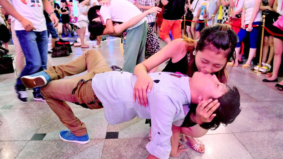 Couples attend a kissing contest during the traditional Qixi festival in Shenyang, northeast China's Liaoning province, on August 13, 2013. - Stringer/AFP/Getty Images