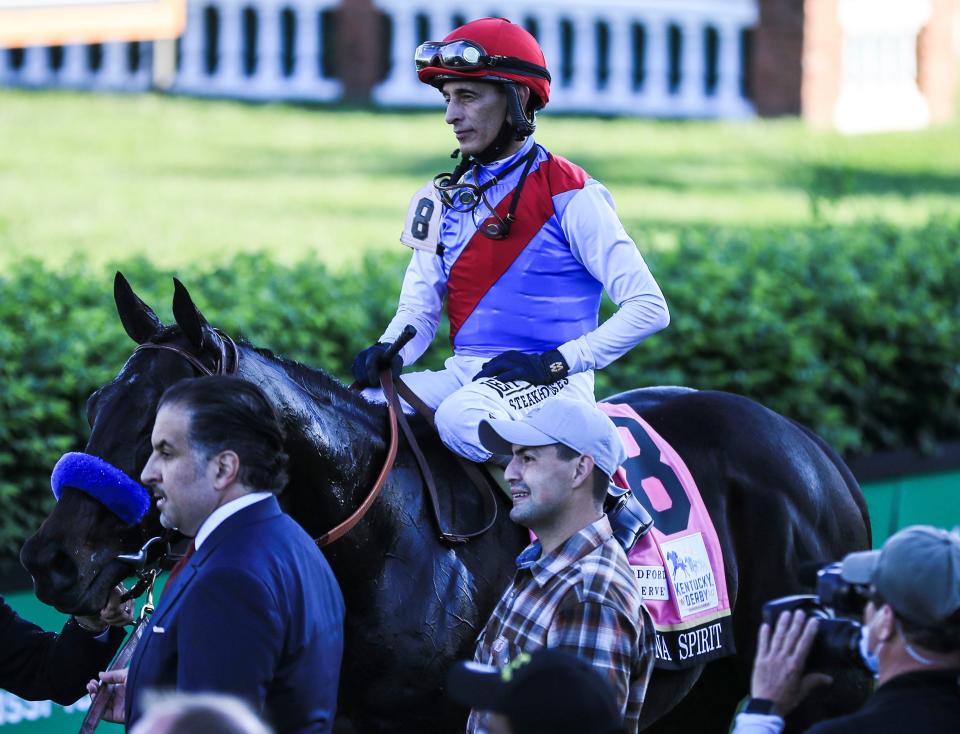 Medina Spirit with jockey John Velazquez head to the Winner's Circle at Churchill Downs after winning the 147th Kentucky Derby. At bottom left is owner Amr Zedan. May 1, 2021