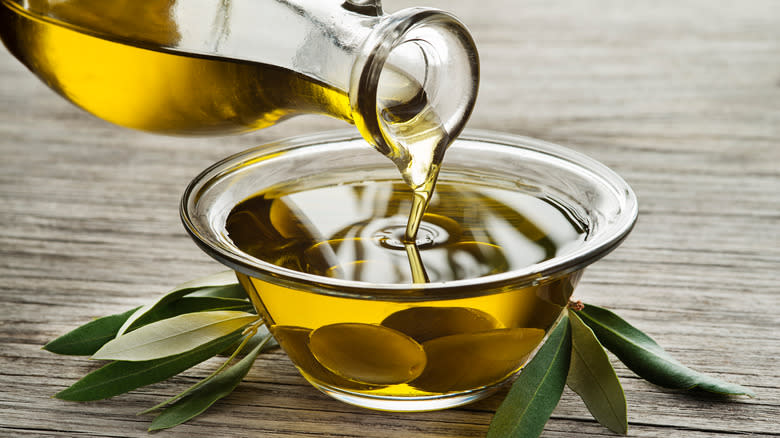 pouring olive oil into bowl