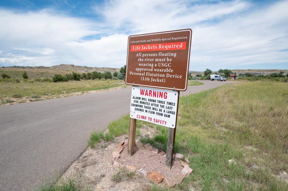 A sign warns life jackets are required to float down the Arkansas River below Lake Pueblo.