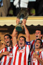 Atletico Madrid's Antonio Lopez (holding cup) celebrates Super Cup victory with Raul Garcia (left) and Reyes (right) (Photo by Neal Simpson - EMPICS/PA Images via Getty Images)