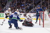 Vancouver Canucks' Adam Gaudette (88) scores against Chicago Blackhawks goalie Corey Crawford (50) during the second period of an NHL hockey game Wednesday, Feb. 12, 2020, in Vancouver, British Columbia. (Darryl Dyck/The Canadian Press via AP)