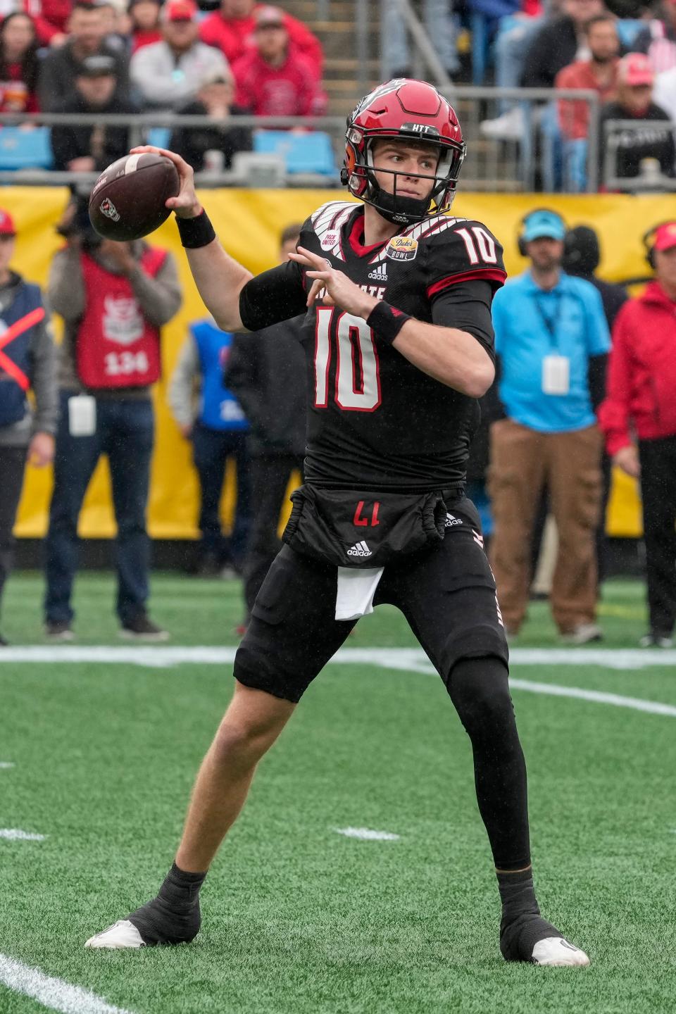 Dec 30, 2022; Charlotte, NC, USA; North Carolina State Wolfpack quarterback Ben Finley (10) drops back to pass during the first half against the Maryland Terrapins in the 2022 Duke's Mayo Bowl at Bank of America Stadium. Mandatory Credit: Jim Dedmon-USA TODAY Sports