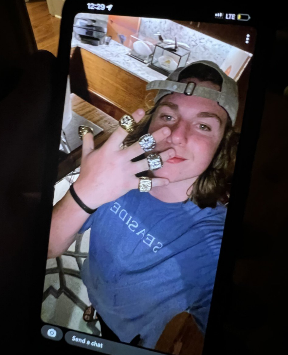 An image shared by the WSCO on Facebook shows a teen flaunting what appears to be championship rings inside the Florida home (Walton County Sheriff’s Office/Facebook)
