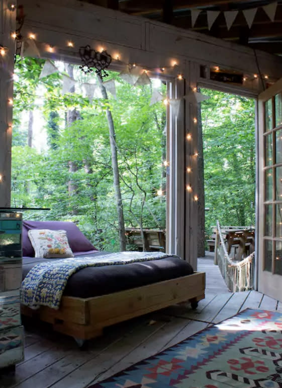 <p>The treehouse consists of a bedroom, living room and a deck, which are all connected by rope bridges. The bedroom features a charming, vintage decor. (Airbnb) </p>