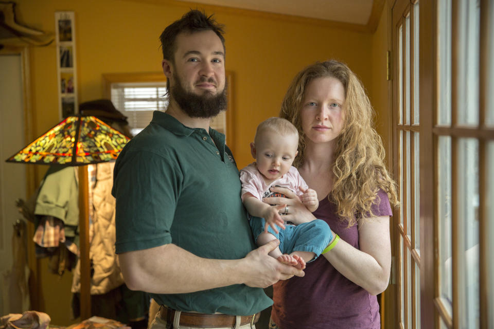 Jeff Decker and his wife Carly Tangney-Decker hold their 8-month daughter Mabel Tangney-Decker in their home on Saturday, Jan. 11, 2014 in Kingston, N.Y. The couple want New York State to legalize medical marijuana, to help their daughter who has a rare genetic disorder that causes seizures. Gov. Andrew Cuomo made a political splash by introducing a medical marijuana plan in the State of the State speech, but his cautious approach has been met with skepticism from pot advocates who question whether the proposal is mostly for show. (AP Photo/Philip Kamrass)