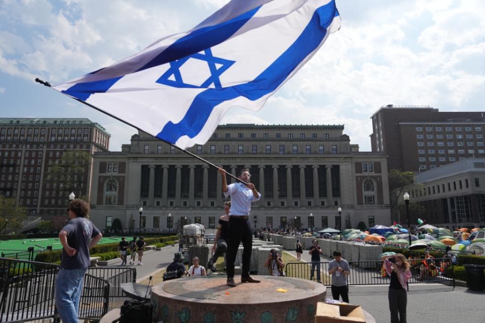 Protestors in support of Israel gather near a pro-Palestinian encampment on the lawn of Columbia University. James Keivom