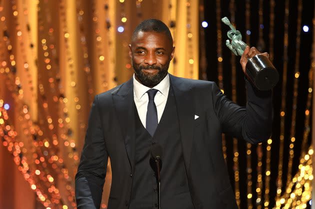 Elba accepts the Male Actor in a Supporting Role award for 