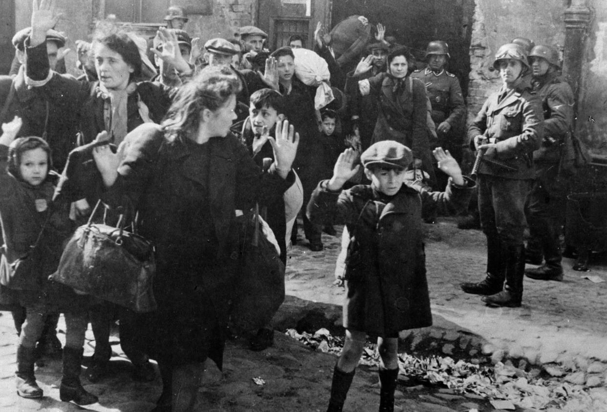 German soldiers force Jewish Poles from their homes and ultimately to their deaths. (Credit: Roger Viollet via Getty Images)