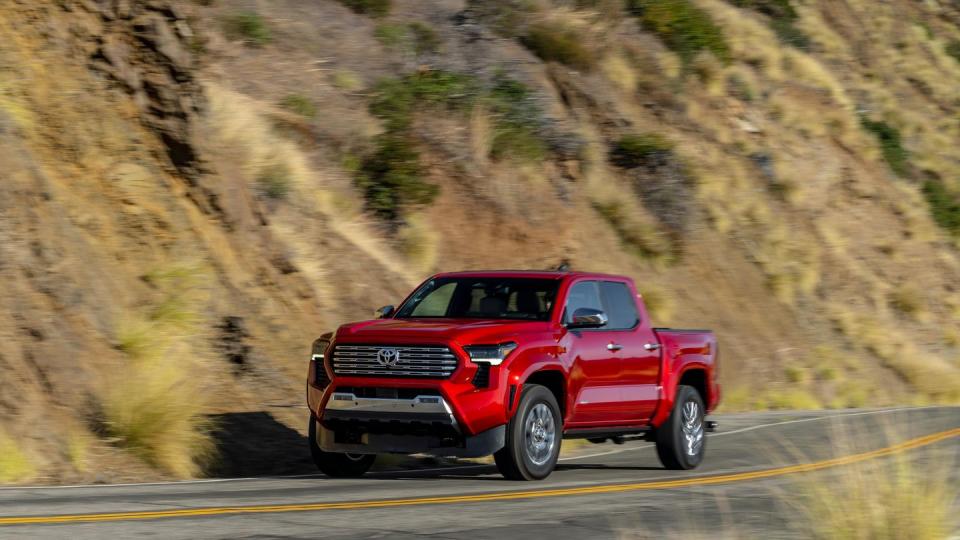 2024 toyota tacoma painted red on mountain road