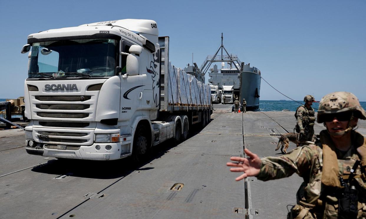 <span>A truck carries humanitarian aid across Trident Pier, a temporary pier to deliver aid, off the Gaza Strip, amid the ongoing conflict between Israel and Hamas, near the Gaza coast, 25 June 2024.</span><span>Photograph: Amir Cohen/Reuters</span>