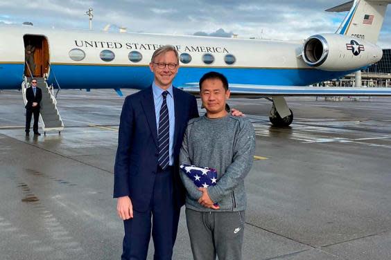 Xiyue Wang, right, with Brian Hook, the US representative for Iran, at an airport in Zurich, Switzerland, following his release from jail in Iran as part of a prisoner swap (AP)