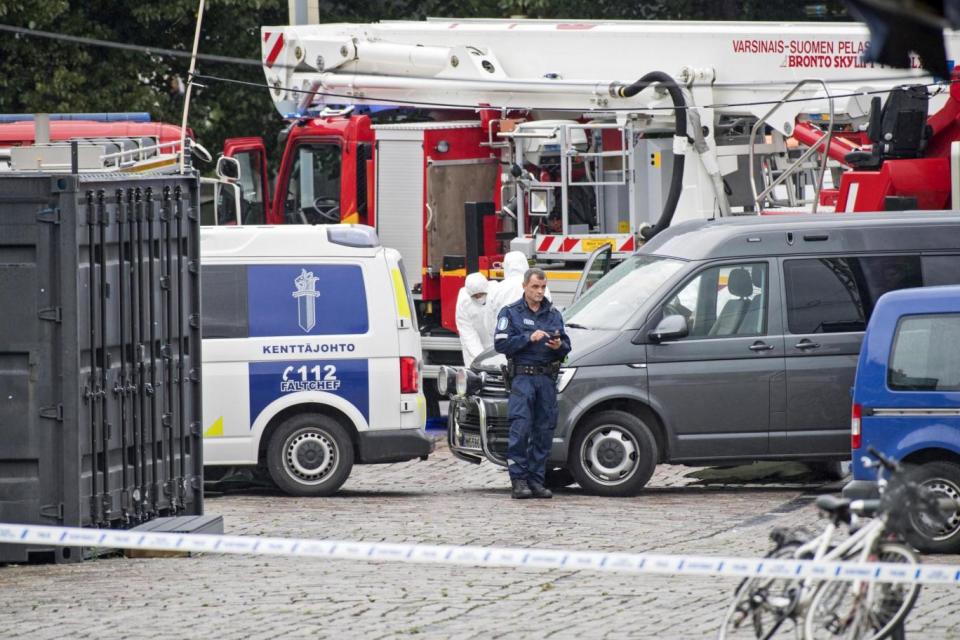 Police officers gather at the site of a multiple stabbing on the Market Square in Turku (EPA)