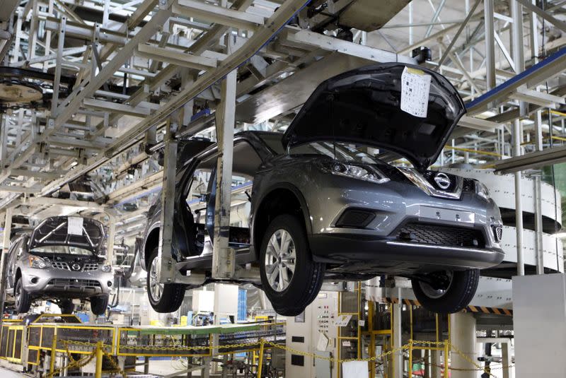 FILE PHOTO: Vehicles of Nissan Motor Co. move on the assembly line at the company's Kyushu plant in Kanda town, Japan