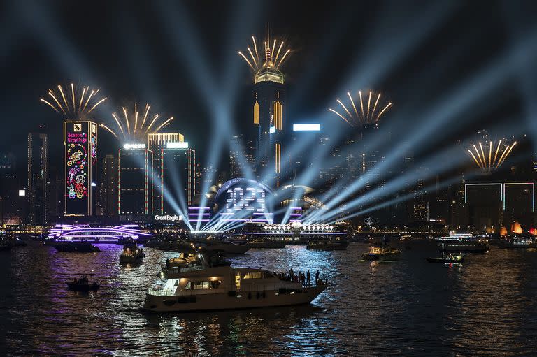 Fireworks are seen over Victoria Harbour at midnight on New Years Sunday Jan. 1, 2023 in Hong Kong. (AP Photo/Anthony Kwan)