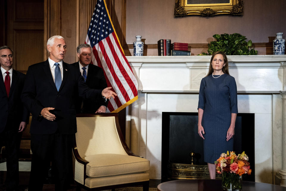 Judge Amy Coney Barrett, President Donald Trump's nominee to the Supreme Court, right, meets with Vice President Mike Pence, left, at the Capitol, Tuesday, September 29, 2020 in Washington in Senate Majority Leader Mitch McConnell of Kentucky's office, not shown. Rear left are White House Counsel Pat Cipollone, left, and White House Chief of staff Mark Meadows. (Erin Schaff/The New York Times via AP, Pool)