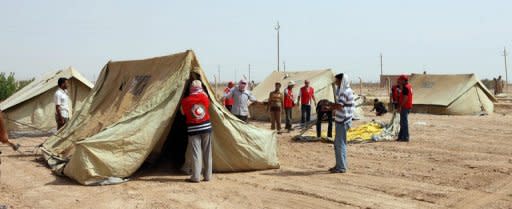 Red Crescent personnel set up tents in the Iraqi town of al-Qaim near the border with Syria