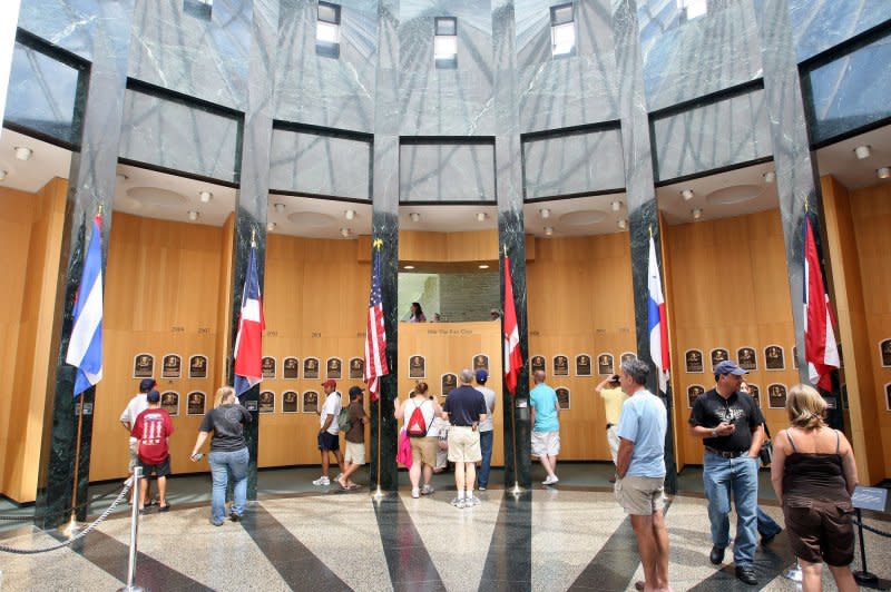 Visitors to the National Baseball Hall of Fame Grand Hall view the Hall of Fame member plaques in Cooperstown, N.Y., on July 25, 2014. On June 12, 1939, the National Baseball Hall of Fame and Museum was dedicated. File Photo by Bill Greenblatt/UPI