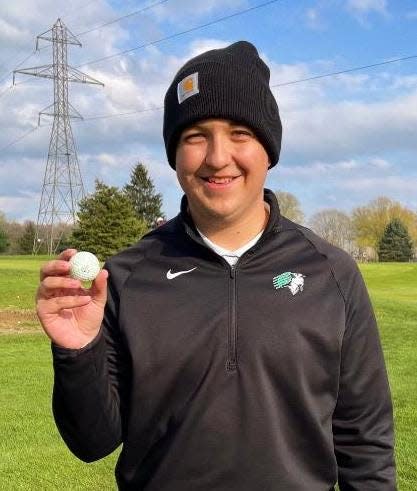 Concord High School junior Charlie Deuel shows off the golf ball he used to ace the par-3, 153-yard eighth hole at Bent Oak Golf Club in Elkhart in a match with Saint Joseph.
