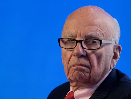 FILE PHOTO: Rupert Murdoch reacts during a panel discussion at the B20 meeting of company CEOs in Sydney, July 17, 2014. REUTERS/Jason Reed//File Photo