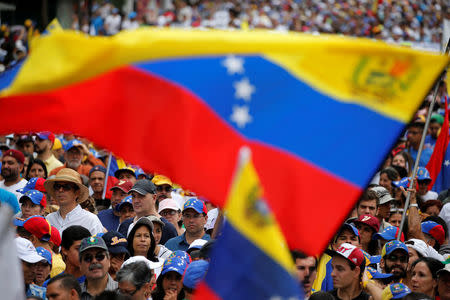 Demonstrators hold Venezuelan flags while rallying against Venezuela's President Nicolas Maduro in Caracas, Venezuela May 1, 2017. REUTERS/Carlos Garcia Rawlins