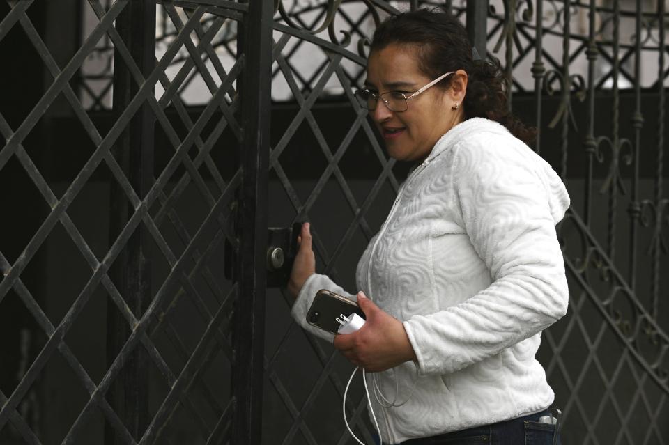 Martha Munoz pushes a gate in Tijuana, Mexico, on Friday, May 12, 2023. She said neighbors have to share updates on WhatsApp about possible water shutoffs and coordinate requests to city authorities when it's cut. (AP Photo/Carlos A. Moreno)