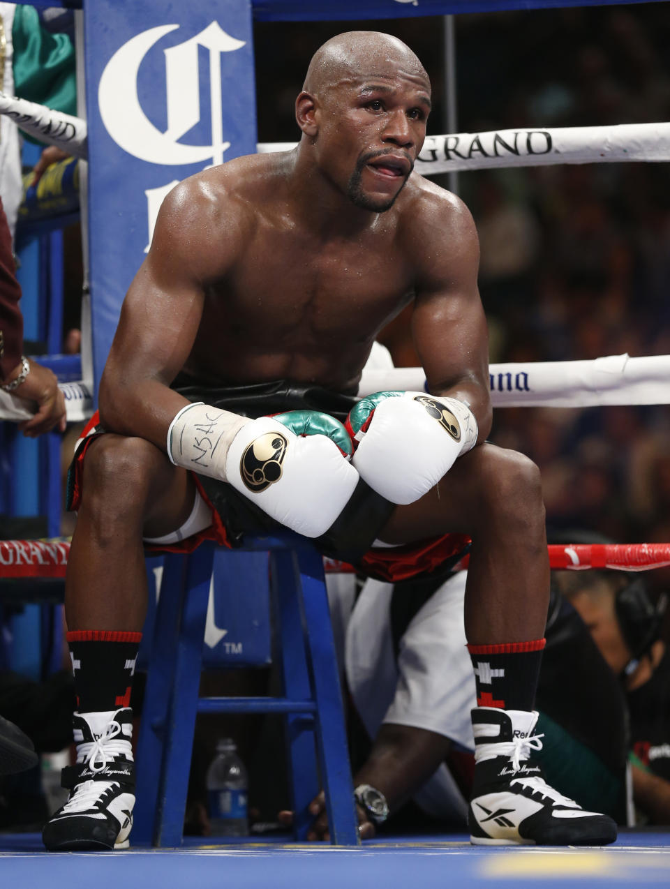 Floyd Mayweather Jr. sits in his corner during his WBC-WBA welterweight title boxing fight against Marcos Maidana Saturday, May 3, 2014, in Las Vegas. (AP Photo/Eric Jamison)