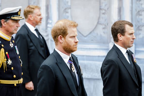 LONDON, ENGLAND - SEPTEMBER 19: Prince Harry, Duke of Sussex and Peter Phillipswalk behind The Queen's funeral cortege borne on the State Gun Carriage of the Royal Navy as it proceeds towards Westminster Abbey on September 19, 2022 in London, England. Elizabeth Alexandra Mary Windsor was born in Bruton Street, Mayfair, London on 21 April 1926. She married Prince Philip in 1947 and ascended the throne of the United Kingdom and Commonwealth on 6 February 1952 after the death of her Father, King George VI. Queen Elizabeth II died at Balmoral Castle in Scotland on September 8, 2022, and is succeeded by her eldest son, King Charles III.  (Photo by Tristan Fewings/Getty Images)