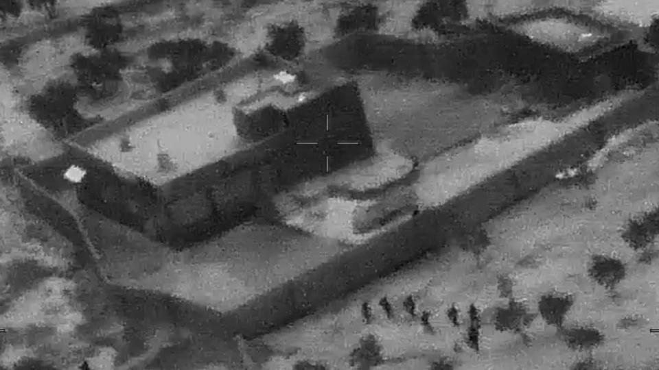 This image from video released by the Department of Defense on Wednesday, Oct. 30, 2019, and displayed at a Pentagon briefing, shows U.S. Special Forces, figures at lower right, moving toward compound of Islamic State leader Abu Bakr al-Baghdadi on Saturday, Oct. 26, 2019. (Photo: Department of Defense via AP)