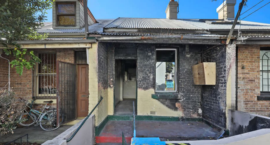 A fire-bombed home in Campbell Street, Glebe is pictured.