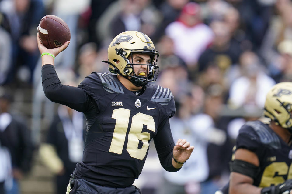 FILE - Purdue quarterback Aidan O'Connell (16) throws a pass against Wisconsin during the first half of an NCAA college football game in West Lafayette, Ind., Saturday, Oct. 23, 2021. Penn State thinks it can unseat Ohio State and Michigan as the top team in the Big Ten East. Purdue believes it can win the wide open Big Ten West. Thursday night's season opener could play a big part in what happens next. (AP Photo/Michael Conroy, File)