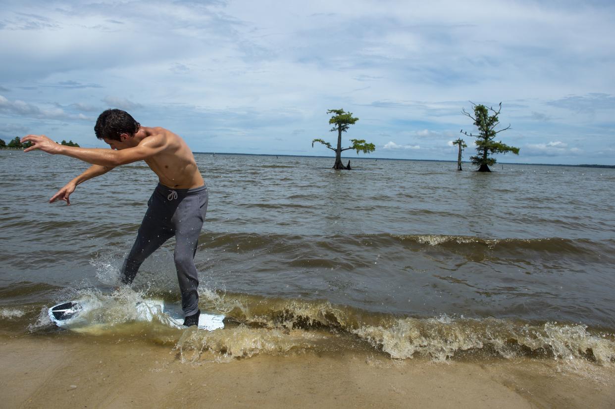 Normally a calm lake, Kane Mason, 17, enjoys the waves that are picking up along Lake Palourde in Morgan City, La. on Saturday, Aug. 28, 2021, as Hurricane Ida begins its approach toward the Louisiana coast.