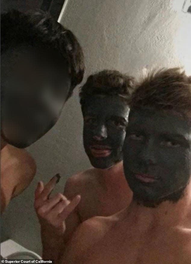 Pictured is Holden Hughes and two unidentified boys wearing green acne facemasks when they were 14 years old in August 2017.