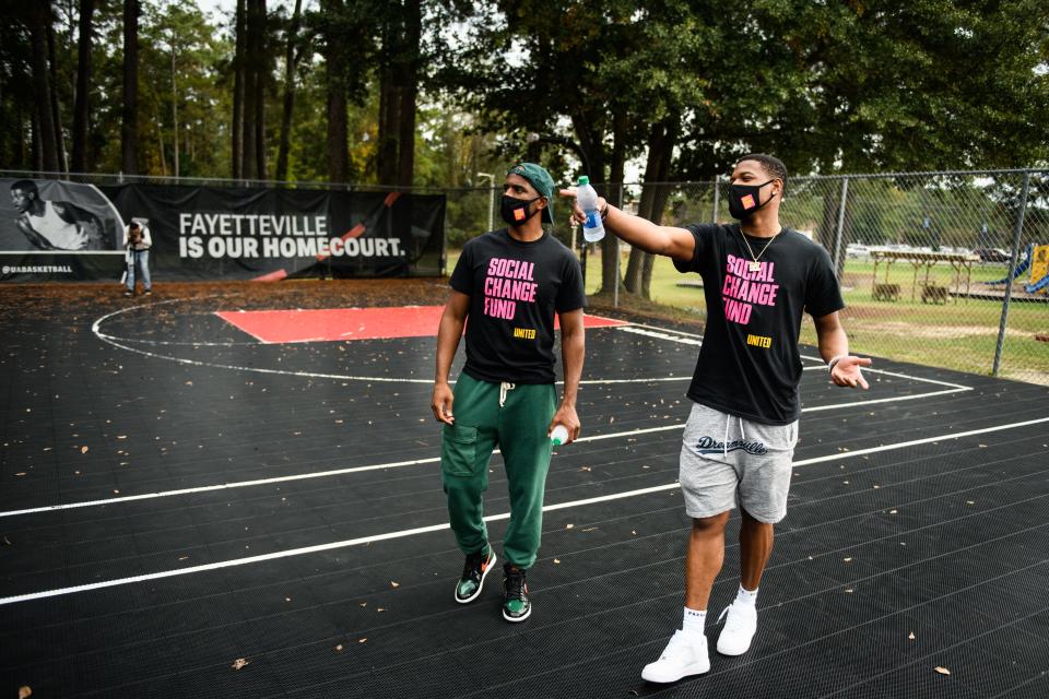 NBA player Dennis Smith Jr., right, shows fellow NBA player Chris Paul the basketball court at Smith Recreation Center on Wednesday, Oct. 28, 2020. Paul is traveling the country going to historically black colleges to get people to vote in the upcoming election.