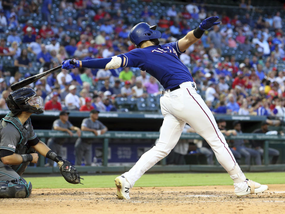 Texas Rangers Joey Gallo (13) follows through on a solo home run in the fourth inning of a baseball game against the Arizona Diamondbacks Tuesday, July 16, 2019 in Arlington, Texas. (AP Photo/Richard W. Rodriguez)