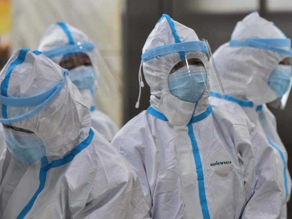 Medical staff members wearing protective clothing to help stop the spread of a deadly virus: AFP via Getty Images