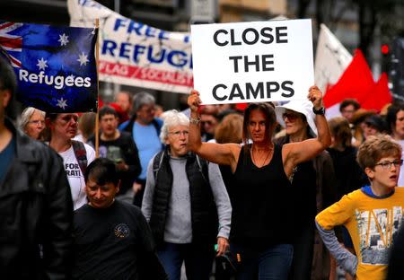 Refugee advocates hold placards as they participate in a protest in central Sydney, against the treatment of asylum-seekers in detention centres located in Nauru and on Manus Island, Australia, October 15, 2017. REUTERS/David Gray