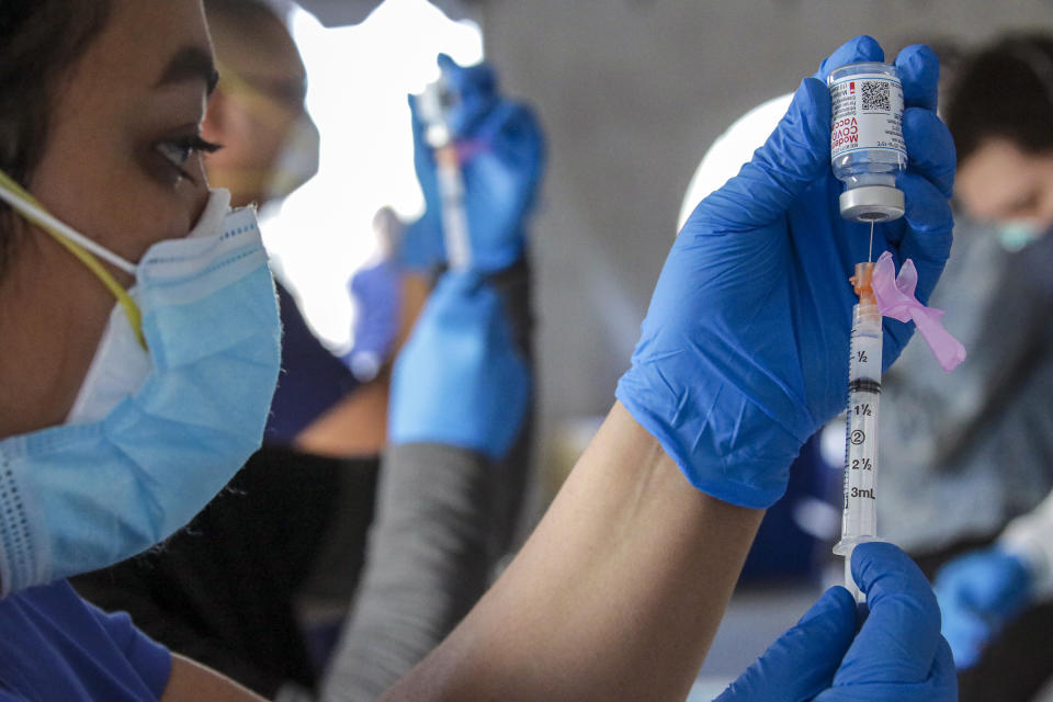 Fontana, CA - February 02: Jacquelyn Zaval, RN, prepares Moderna mRNA-1273 vaccine at a super site COVID-19 vaccination event held by San Bernardino County health at Auto Club Speedway on Tuesday, Feb. 2, 2021 in Fontana, CA.(Irfan Khan / Los Angeles Times via Getty Images)