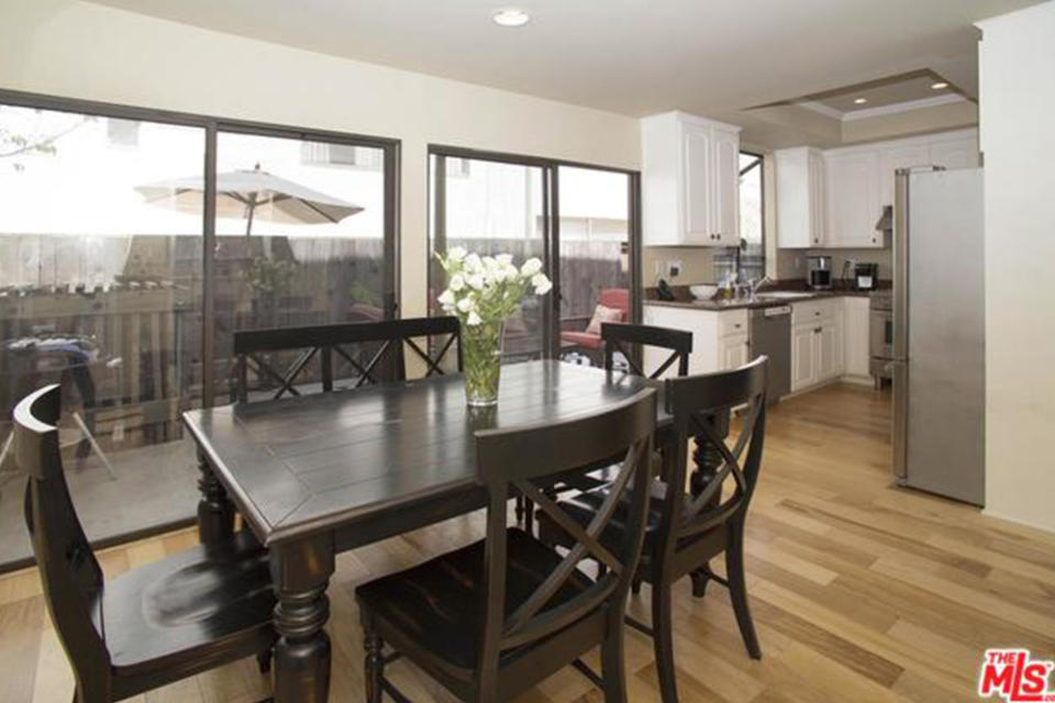 <p>The living room is connected to a dining area with large sliding doors and access to the patio. (Trulia.com) </p>